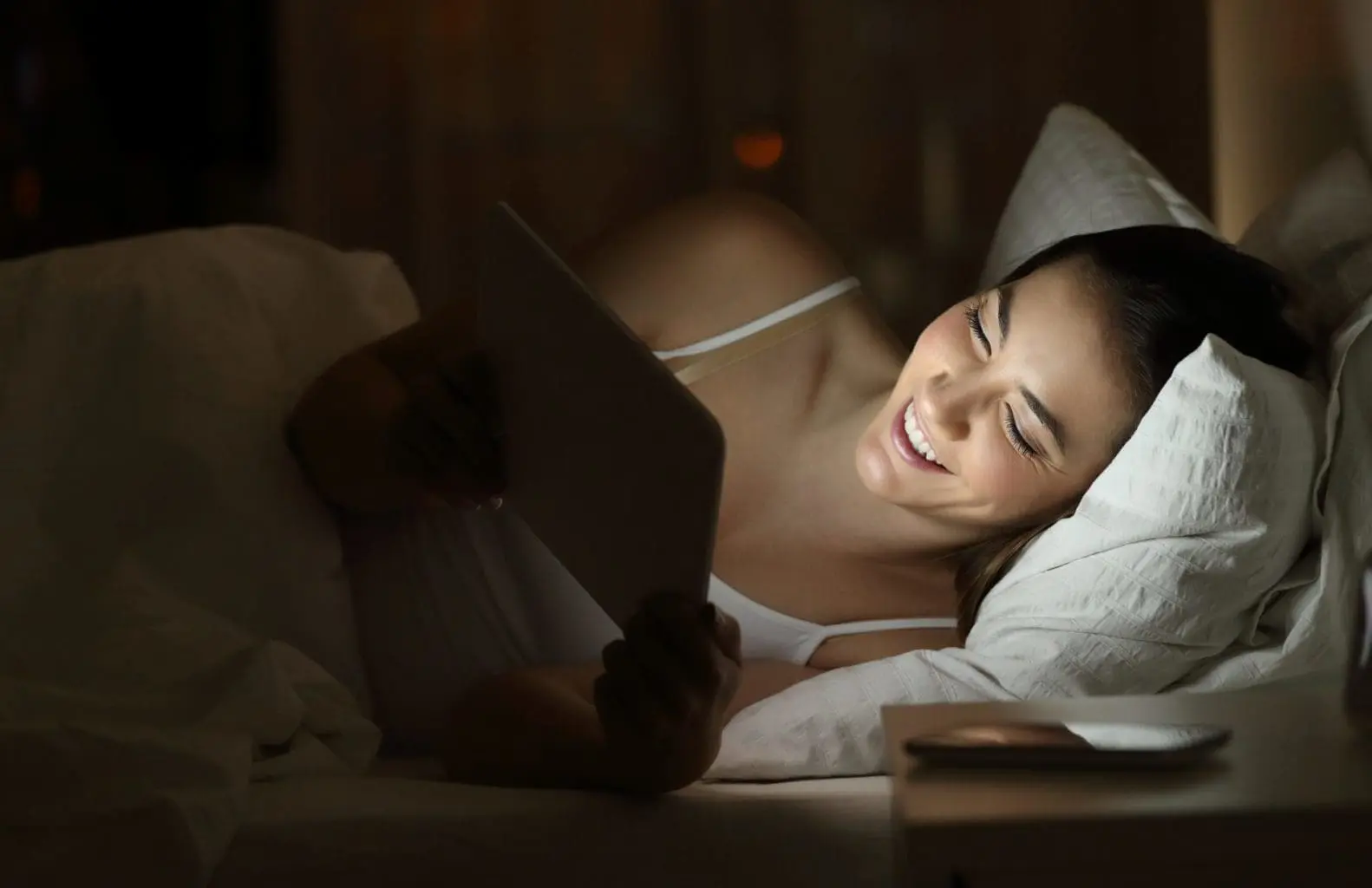 bigstock-Happy-Woman-Watching-Tv-Or-Med-234883177B