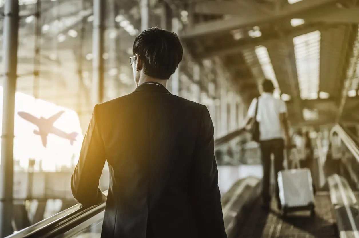 business traveler at the airport while navigating to their gate
