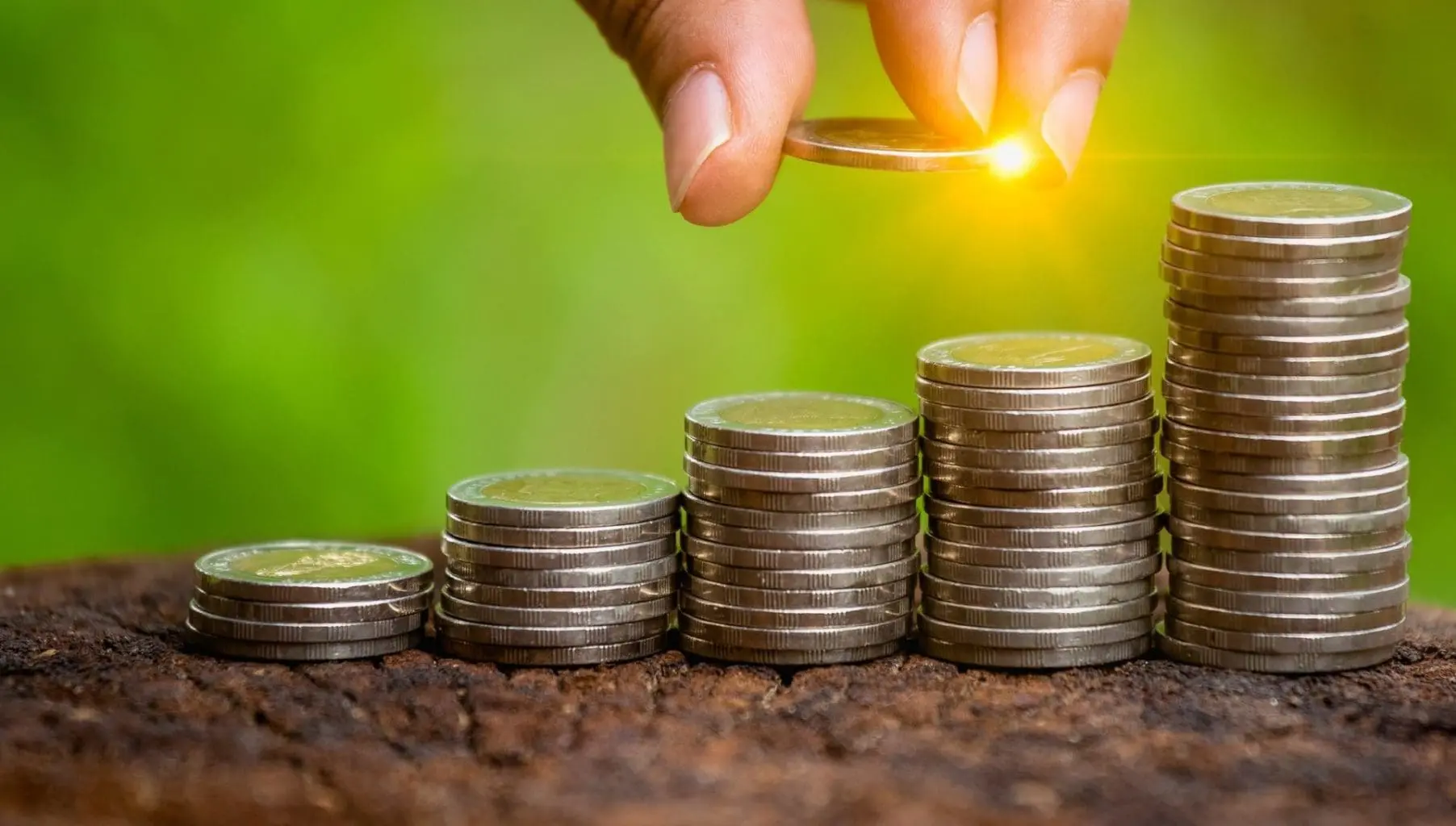bigstock-A-Hand-Putting-Money-Coins-Sta-319467874B