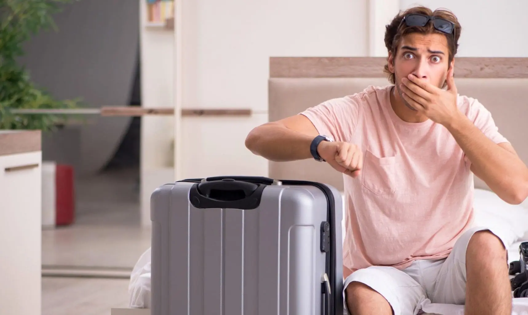 bigstock-Man-with-suitcase-in-bedroom-w-292862227B